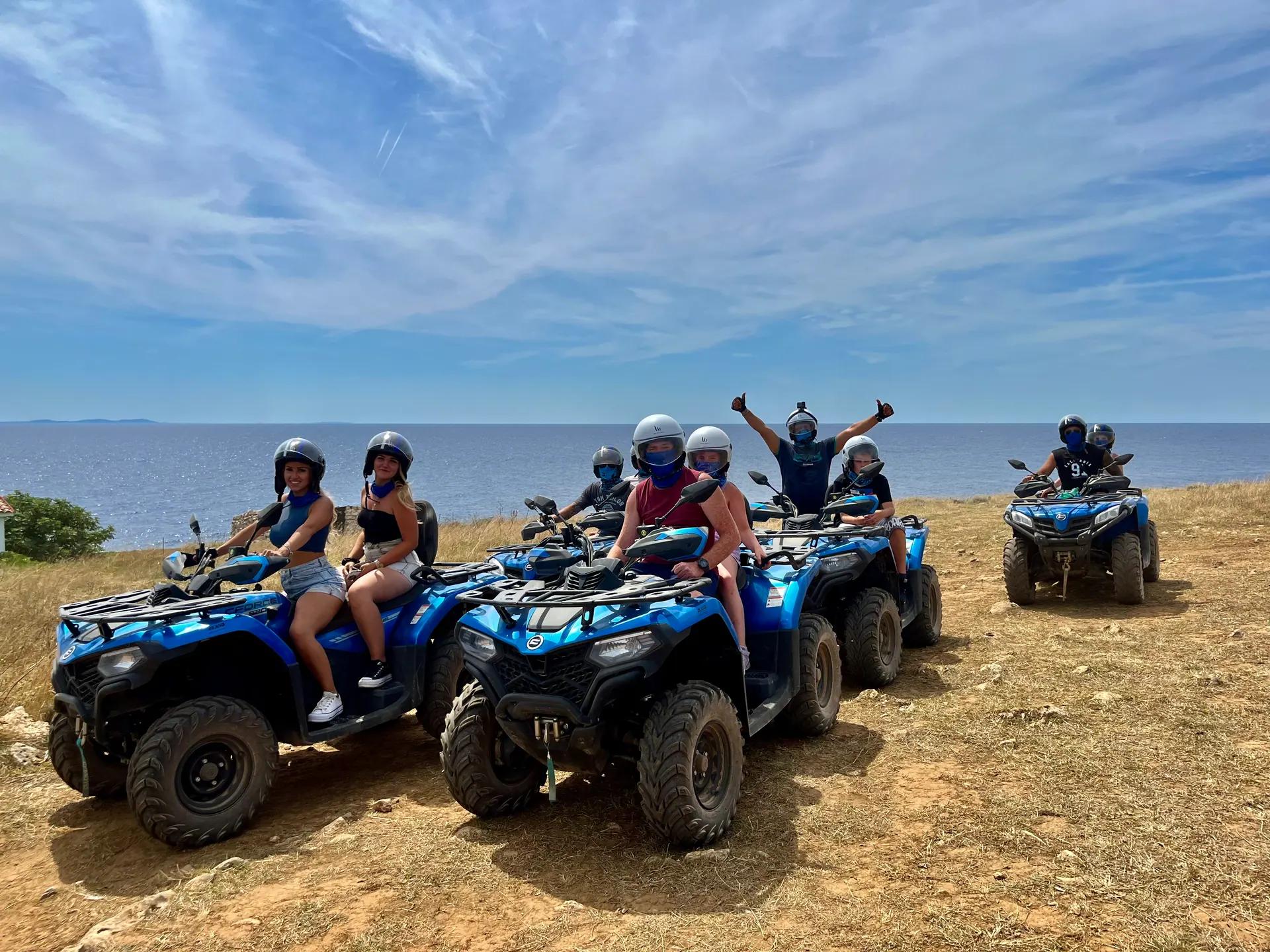 Quad riders following the Medulin coastline at sunset